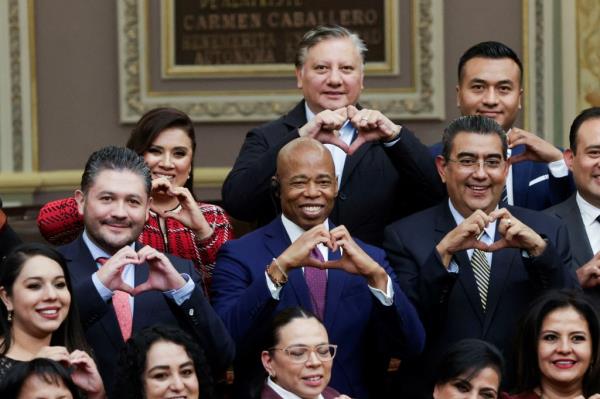 Adams made hand hearts with members of the State of Puebla local assembly on Oct. 5.